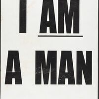An all-caps typed poster reading "I AM A MAN" with "am" underlined. The poster is slightly smudged
and wrinkled.